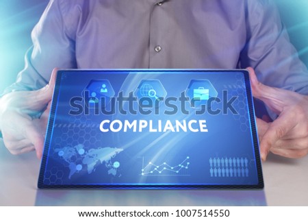 Business, Technology, Internet and network concept. Young businessman working on a virtual screen of the future and sees the inscription: Compliance