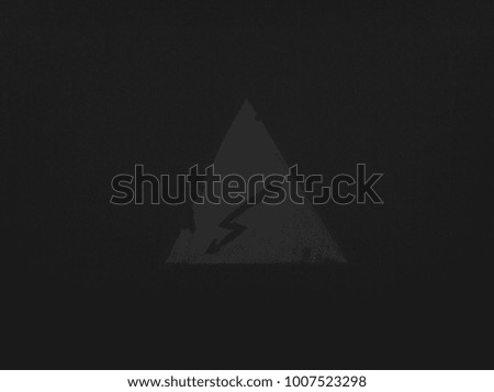 sign of lightning in a triangle on a dark background