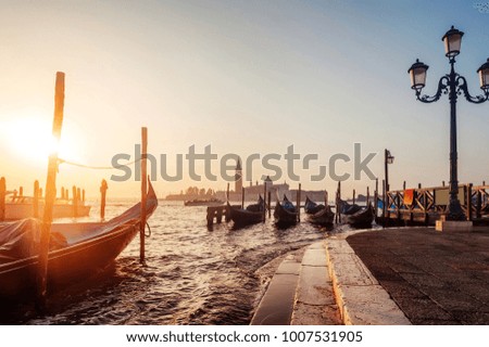 famous gondolas at sunrise in Venice, Italy. picture with long exposure