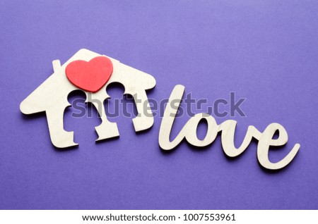 family house with red heart over ultraviolet background