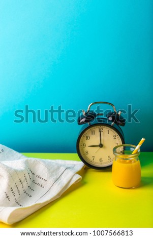 morning table 9 o'clock alert orange juice breakfast blue and yellow background