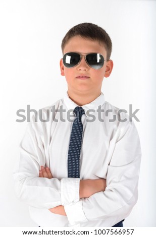 Portrait of young businessman of boy in a shirt and spectacled. Successful teenager isolated on a white background.