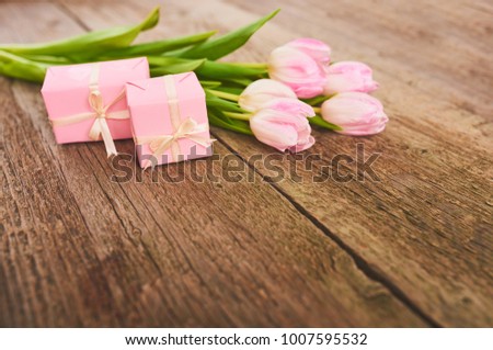 Valentines day background with pink tulips and gift box