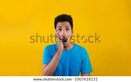 Worried or scared man isolated on a yellow background. Concept image for social media and advertisements.