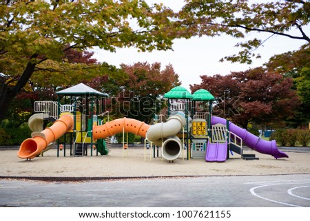 Colorful play ground  toy set for children school or public city park in autumn with nobody.