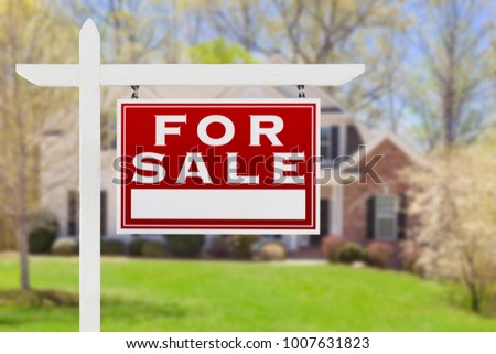 Right Facing For Sale Real Estate Sign In Front of House.