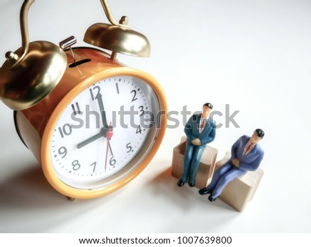 Selective focus image of miniature people with alarm clock, time for savings money concept or business financial idea. / with copy space