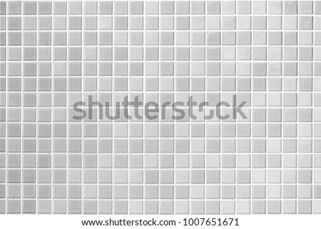 White or gray ceramic wall and floor tiles abstract background. Design geometric mosaic texture for the decoration of the bedroom. Simple Seamless Poly art or Hypnotic at kaleidoscope.