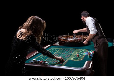 Croupier and woman player at a table in a casino. Picture of a c