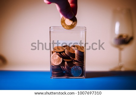 A hand taking money to save,investment,Taiwan money,vintage tone. Royalty-Free Stock Photo #1007697310