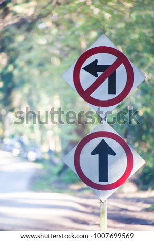 Don't turn left sign and go ahead the way,forward sign and  with nature background.