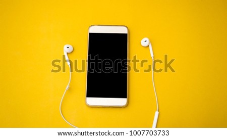 smartphone and earphone business concept yellow background