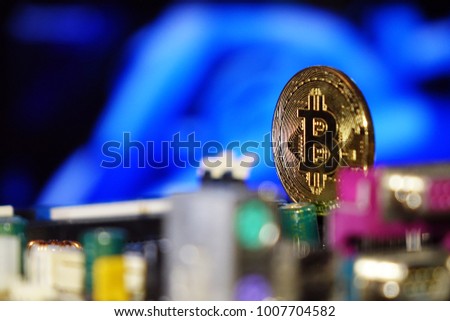 Cryptocurrency bitcoin gold. Bitcoins on the motherboard.