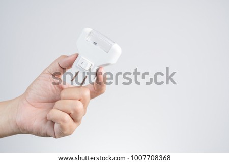 Hand holding wall LED light plug, and electric outlet