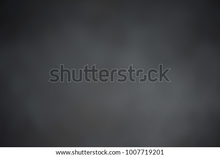Abstract blurred dark background.