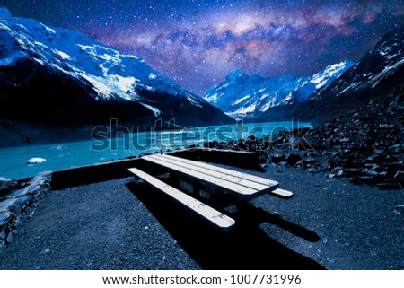 Resting wooden table and chair with wilkyway background at Mount Cook, New Zealand