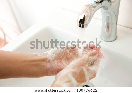 Washing of hands with soap under running water. Royalty-Free Stock Photo #100776622
