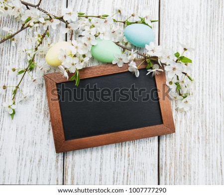Easter eggs and greeting card on a old wooden background