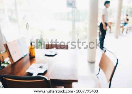 Empty chaiR blurred cafe bokeh with people in coffee shop