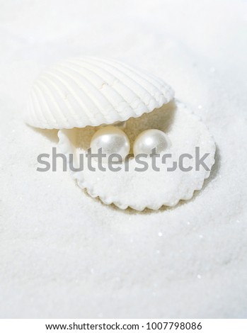 Pearls and shells on the sand