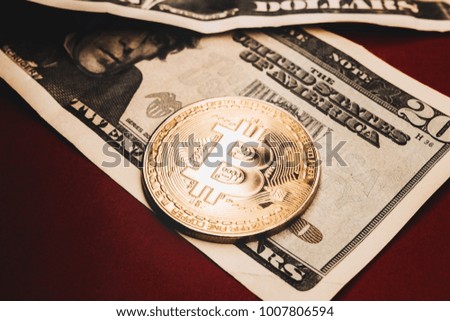 Gold coin bitcoin on a background of red paper. Money. Dollars.