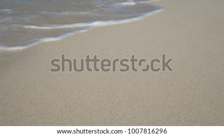 soft wave of blue ocean on sandy white beach. summer background.