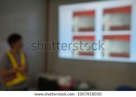 Blurred photograph of on construction site presentation with peoples who wear reflective safety jacket Royalty-Free Stock Photo #1007818030