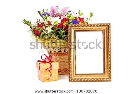 Gift box and golden picture frame with flowers on white background