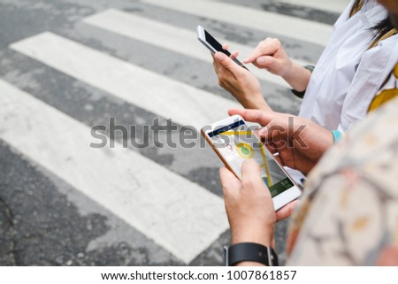 Traveler use map on mobile phone app to search for route location of place with gps on street when travel in city,Technology in lifestyle 