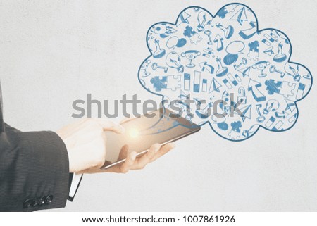Side view of businessman hand using glowing tablet with creative business sketch. Idea and finance concept 