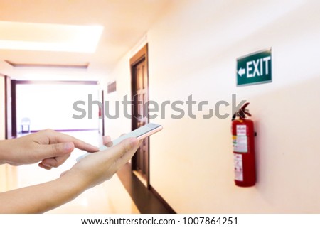Men use mobile phones in the fire escape area of the building.