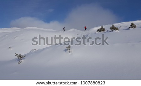Trekkers walking in the snowy mountains