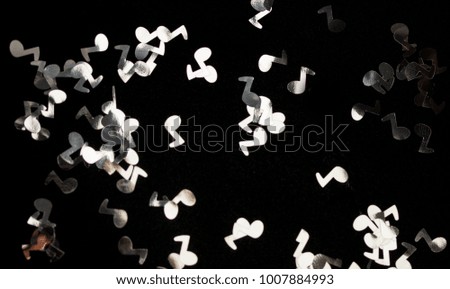 confetti notes on a black background