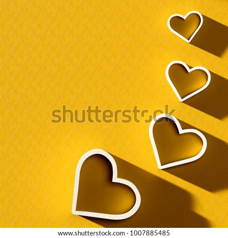 3D render of valentine's day card. Set of white plastic hearts card on gold background with clear shadow
