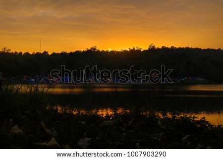 The sunset behind mountain and lake.