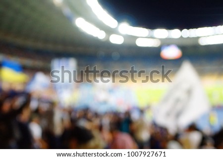 vintage tone blur image of soccer stadium in twilight time for abstract background usage.