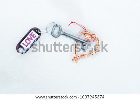 Flat lay , heart made of woven of willow twigs and steel key white blank with violet Love text symbol sign . Concept of path to heart. Valentines Day , 14 February. Snow Background , copy paste space.