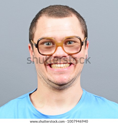 Portrait of a geek looking guy with huge glasses