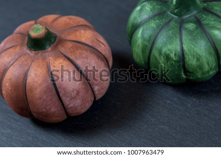 Little colored pumpkins on a black background