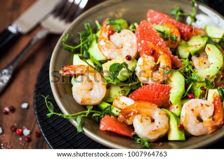 Delicious fresh salad with prawns, grapefruit, avocado, cucumber and herbs Royalty-Free Stock Photo #1007964763