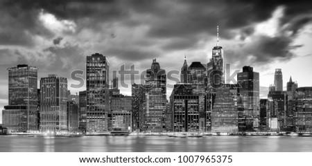 Black and white panoramic picture of the New York City skyline at dusk, USA.