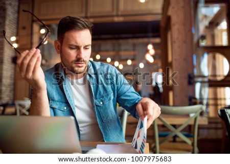 Modern young student learning at coffee shop Royalty-Free Stock Photo #1007975683