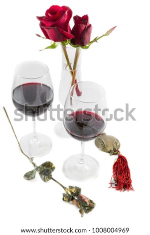 Two Roses Red Wine Glasses and Metallic Rose and Pomegranate on white background Valentines Day composition