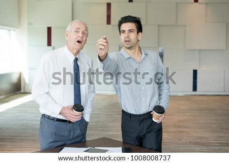 Two Astonished Coworkers Viewing Presentation