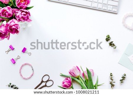 Spring flowers on workdesk at home white background top view moc Royalty-Free Stock Photo #1008021211