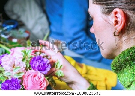 Florist at work makes the composition of colors in a gift box