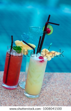 Three cocktail drinks by a tropical hotel resort, Thailand, exotic cocktails in pool bar on the beach