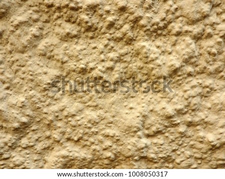 Structure of the background of uneven decorative ocher stucco.