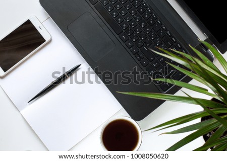 Laptop, notepad and phone on your desktop