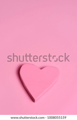 closeup of a pink three-dimensional heart on a pink background, with a blank space on top